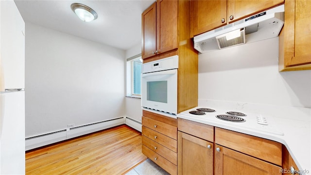 kitchen with white appliances and a baseboard heating unit