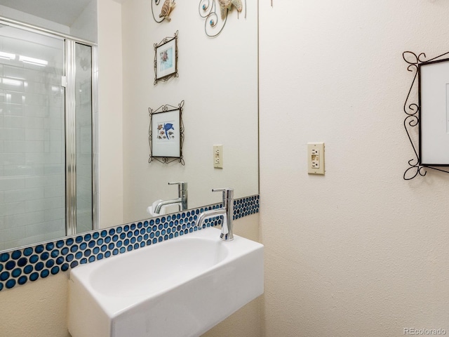 bathroom featuring sink and an enclosed shower