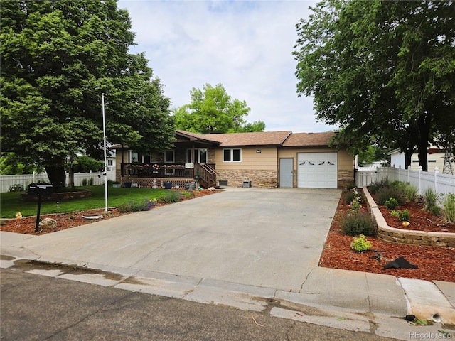 720 W 4th St, Julesburg, CO 80737 - view of front of home with a garage, driveway, and stone siding