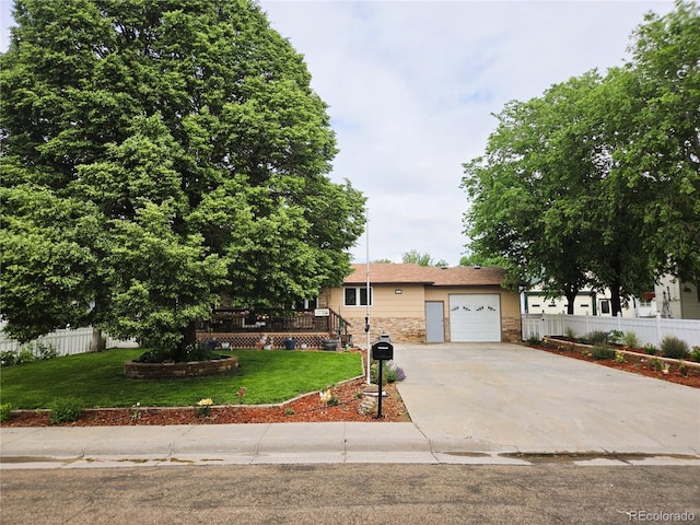 720 W 4th St, Julesburg, CO 80737 - view of front of property featuring concrete driveway, an attached garage, a deck, and stone siding