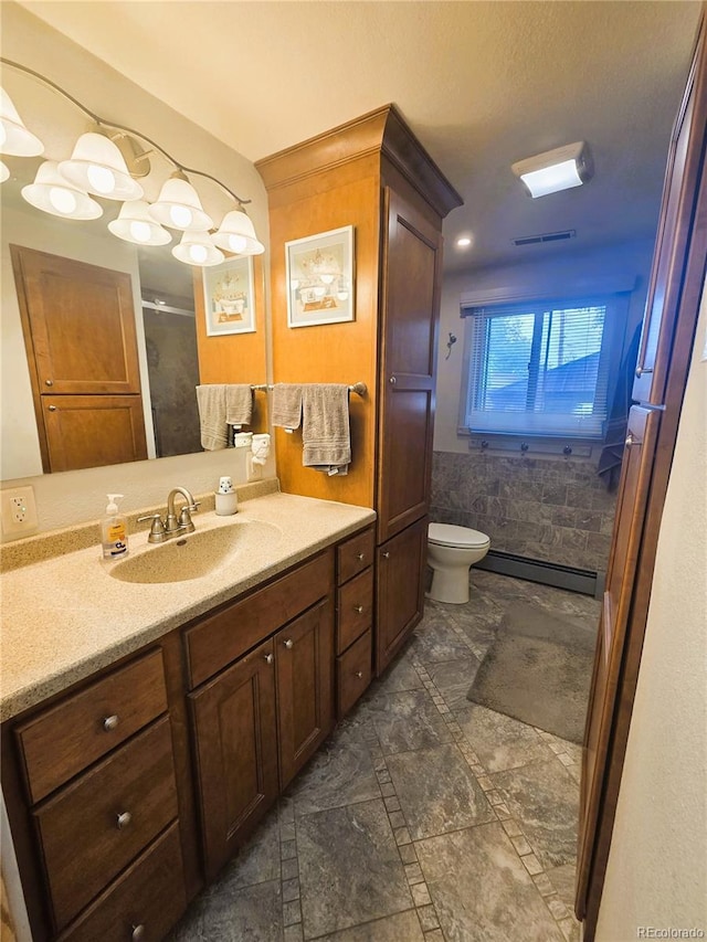 720 W 4th St, Julesburg, CO 80737 - full bathroom featuring a baseboard radiator, vanity, toilet, and a shower
