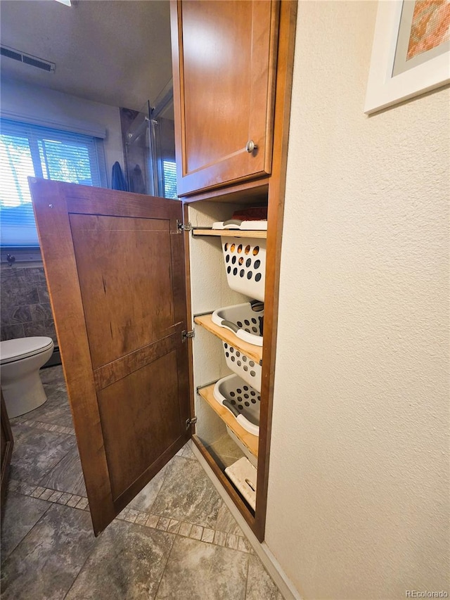 720 W 4th St, Julesburg, CO 80737 - bathroom featuring toilet and a textured wall