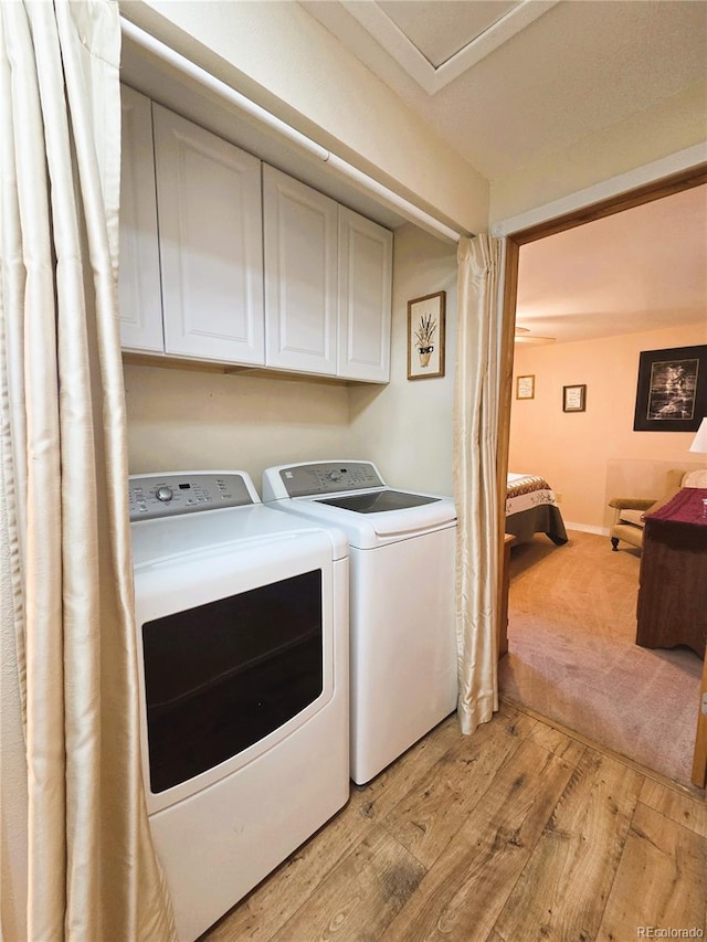 720 W 4th St, Julesburg, CO 80737 - washroom featuring cabinet space, washing machine and dryer, and light wood-type flooring