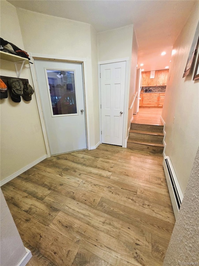 720 W 4th St, Julesburg, CO 80737 - hallway with a baseboard radiator, wood finished floors, recessed lighting, and stairs