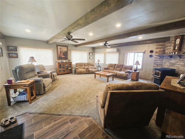 720 W 4th St, Julesburg, CO 80737 - living area featuring a ceiling fan, a wood stove, a wall unit AC, beam ceiling, and recessed lighting