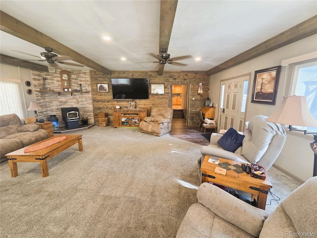 720 W 4th St, Julesburg, CO 80737 - carpeted living area with a ceiling fan, a wood stove, plenty of natural light, recessed lighting, and beamed ceiling