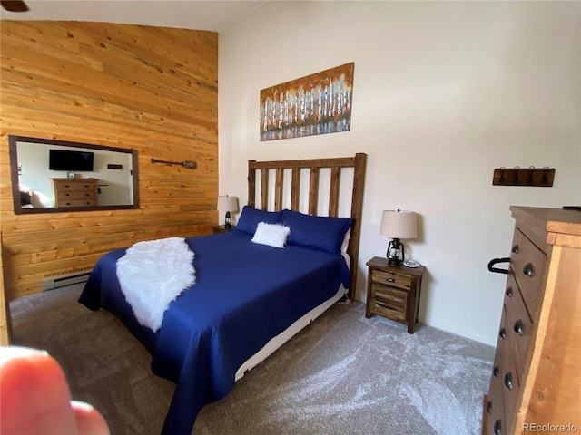 bedroom with carpet floors, a baseboard radiator, and wooden walls