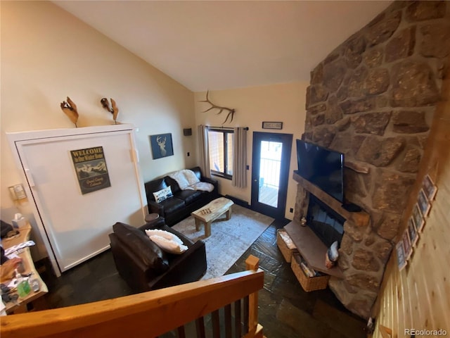 living room with lofted ceiling and a fireplace