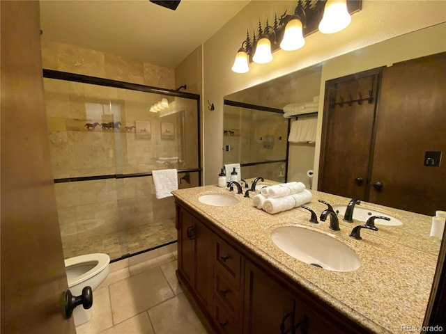 full bathroom featuring a stall shower, a sink, and toilet