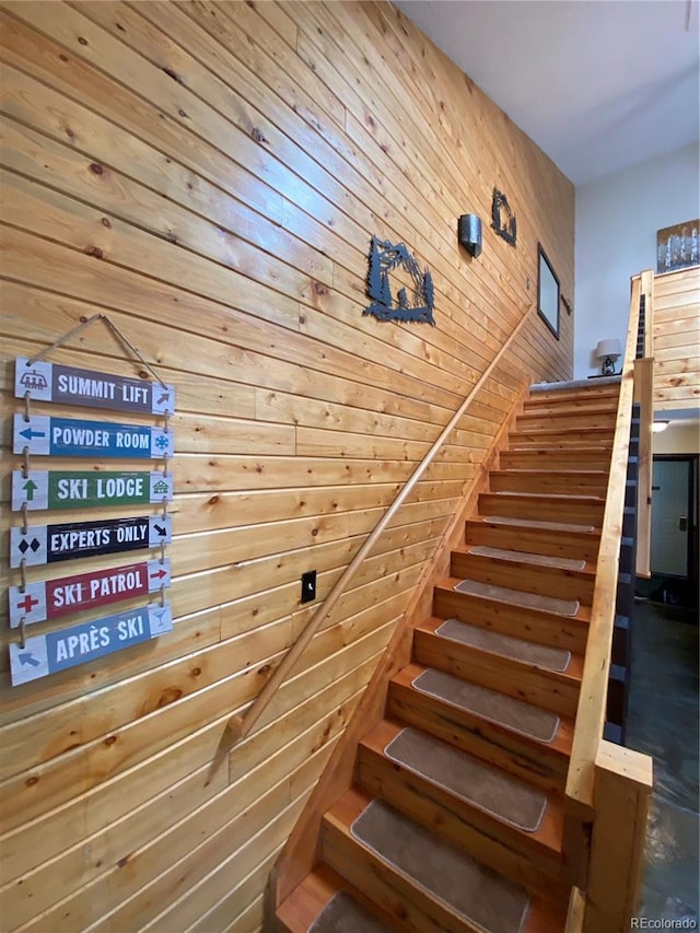 stairs featuring wooden walls