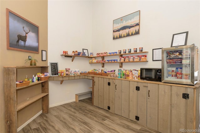 interior space with light wood-style flooring and wine cooler