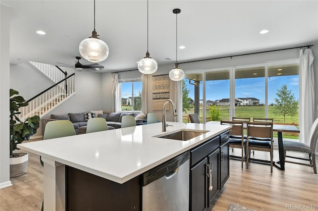 6513 Dry Fork Cir, Frederick, CO 80516 - kitchen with dishwasher, light countertops, light wood-style floors, decorative light fixtures, and open floor plan