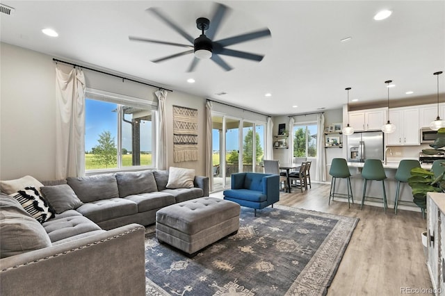6513 Dry Fork Cir, Frederick, CO 80516 - living area featuring a ceiling fan, recessed lighting, and light wood-style floors