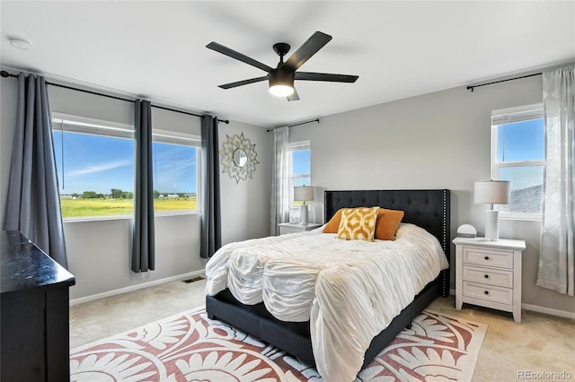 6513 Dry Fork Cir, Frederick, CO 80516 - bedroom with light colored carpet, multiple windows, and ceiling fan