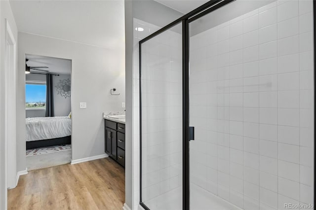 6513 Dry Fork Cir, Frederick, CO 80516 - bathroom with ensuite bathroom, vanity, wood finished floors, a shower stall, and ceiling fan