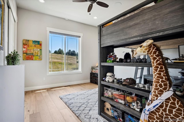 bedroom featuring ceiling fan and light hardwood / wood-style flooring