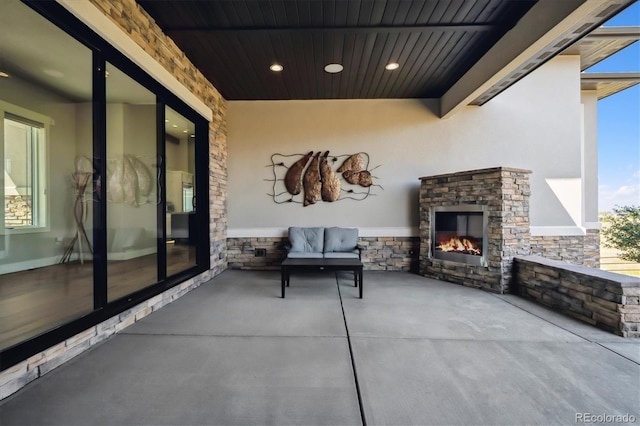 view of patio / terrace with an outdoor stone fireplace