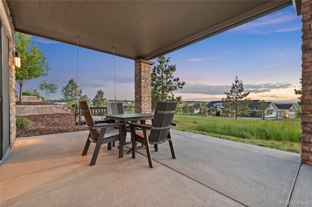 view of patio terrace at dusk