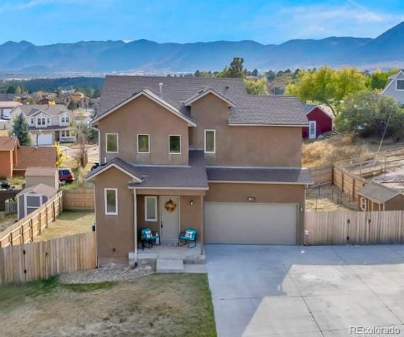 861 Circle Rd, Palmer Lake, CO 80133 - traditional-style house with covered porch, driveway, a garage, a mountain view, and stucco siding