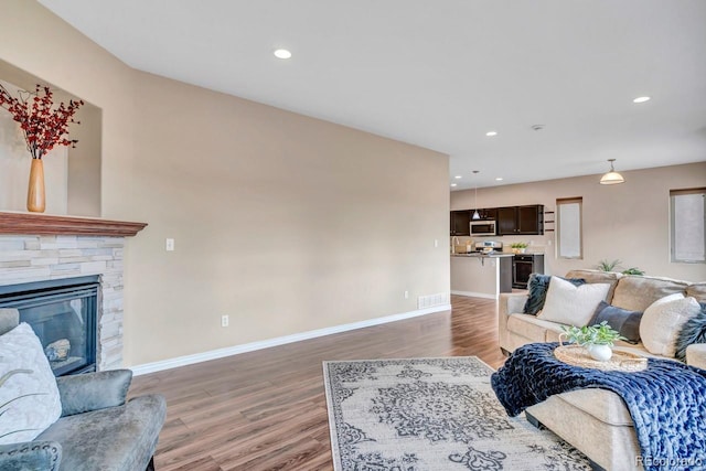 861 Circle Rd, Palmer Lake, CO 80133 - living room featuring a fireplace, recessed lighting, baseboards, and light wood-style floors
