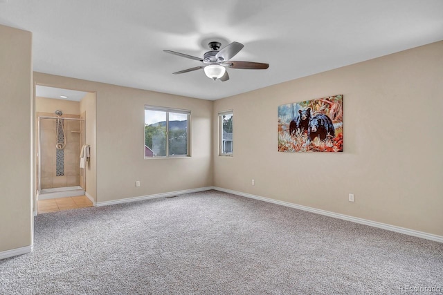861 Circle Rd, Palmer Lake, CO 80133 - unfurnished bedroom with connected bathroom, baseboards, light carpet, and ceiling fan