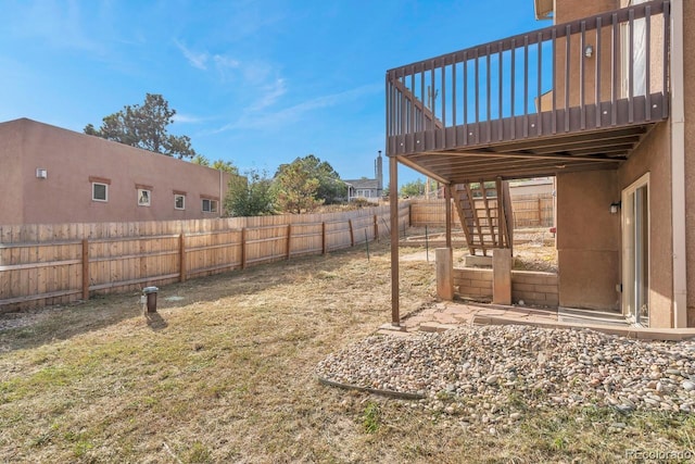 861 Circle Rd, Palmer Lake, CO 80133 - view of yard with a fenced backyard, a wooden deck, and stairway