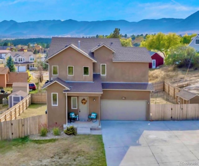 861 Circle Rd, Palmer Lake, CO 80133 - view of front of home featuring a mountain view, an attached garage, stucco siding, concrete driveway, and a gate