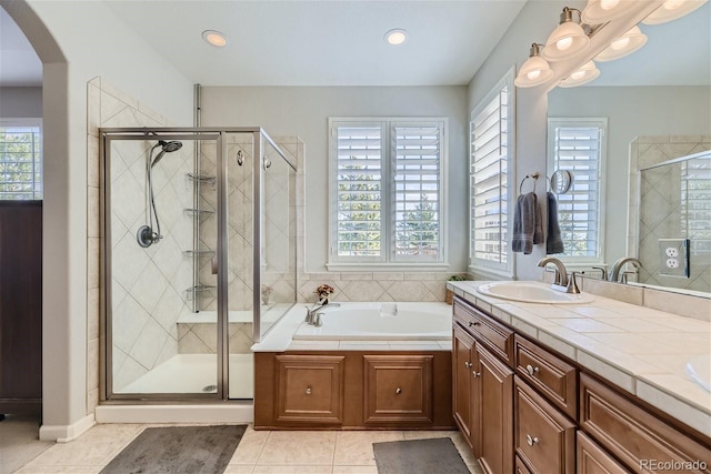 bathroom with vanity, tile flooring, and separate shower and tub