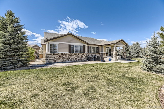 rear view of house with a lawn and a patio area