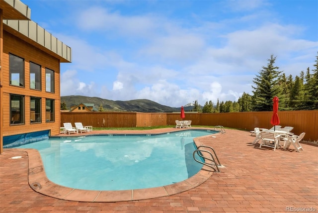 309 Eastridge Dr, Dillon, CO 80435 - view of swimming pool with a fenced backyard, a mountain view, a patio area, and outdoor dining area