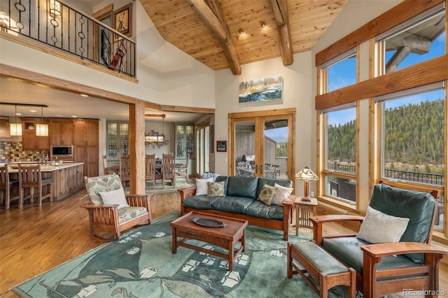 309 Eastridge Dr, Dillon, CO 80435 - living area featuring light wood-type flooring, high vaulted ceiling, and a wood ceiling with exposed beams