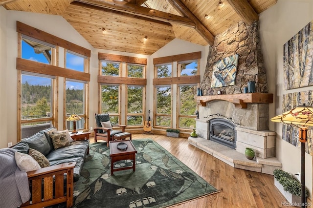 309 Eastridge Dr, Dillon, CO 80435 - living room with a wooden ceiling with exposed beams, healthy amount of natural light, hardwood / wood-style floors, a fireplace, and high vaulted ceiling