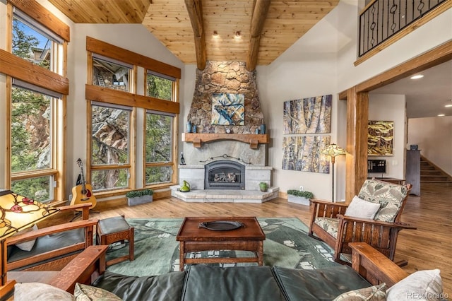 309 Eastridge Dr, Dillon, CO 80435 - living room featuring wood finished floors, a wood ceiling with exposed beams, a stone fireplace, stairway, and high vaulted ceiling