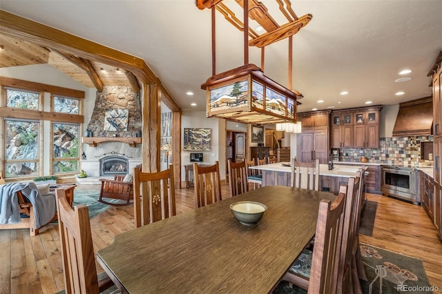 309 Eastridge Dr, Dillon, CO 80435 - dining room featuring light wood-type flooring, a fireplace, and recessed lighting