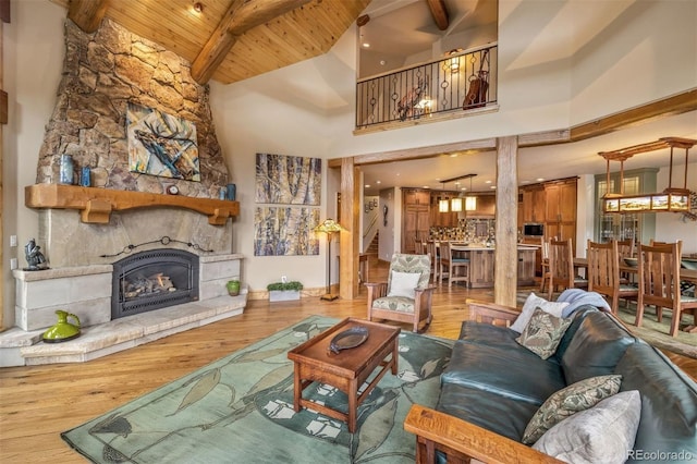 309 Eastridge Dr, Dillon, CO 80435 - living room featuring a wooden ceiling with exposed beams, wood finished floors, a fireplace, and high vaulted ceiling