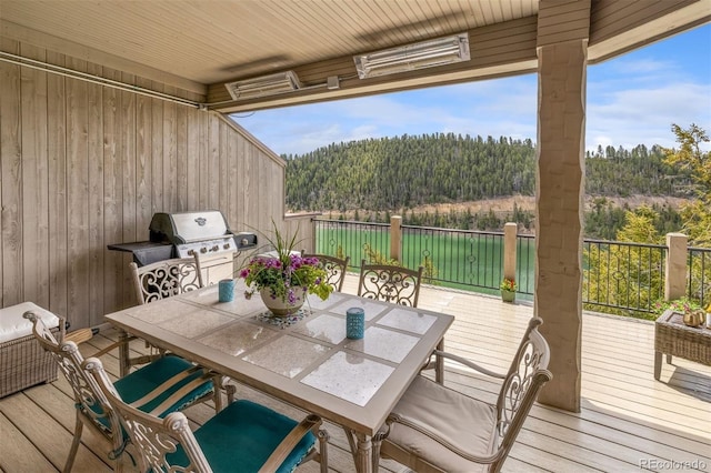 309 Eastridge Dr, Dillon, CO 80435 - deck with a forest view, outdoor dining area, and area for grilling