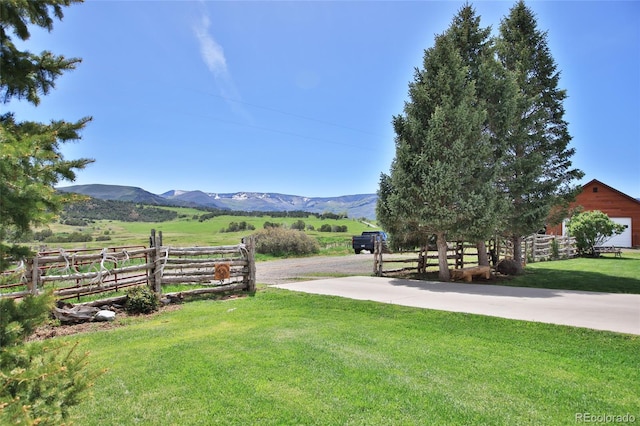 view of yard featuring a rural view and a mountain view