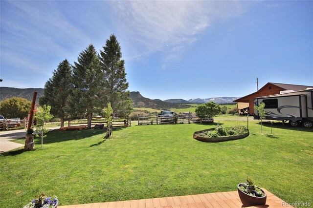 view of yard featuring a rural view and a mountain view