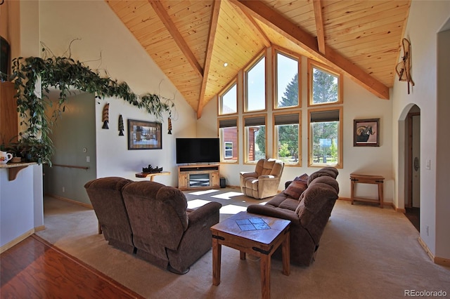 carpeted living room featuring high vaulted ceiling, beam ceiling, wood ceiling, and a fireplace