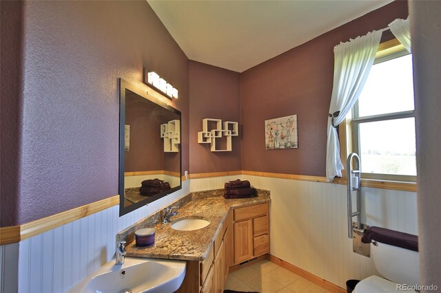 bathroom featuring vanity, toilet, and tile floors