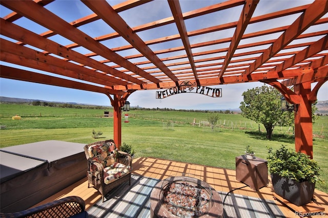 view of patio / terrace with a pergola, an outdoor fire pit, and a rural view