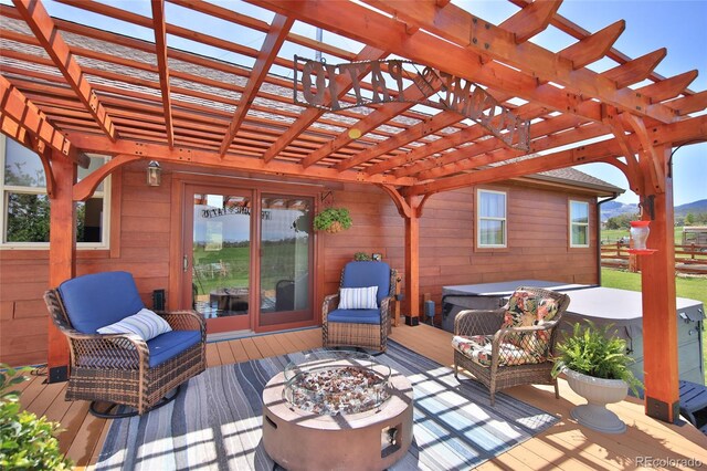 deck with a pergola and a fire pit