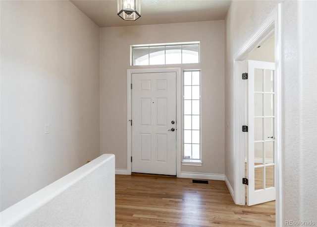 foyer featuring a healthy amount of sunlight and light hardwood / wood-style floors