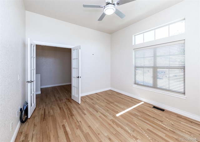 empty room with ceiling fan and light wood-type flooring