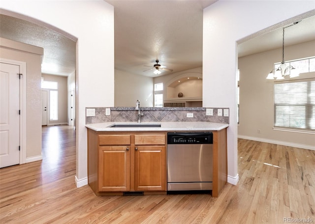 kitchen with light hardwood / wood-style flooring, dishwasher, ceiling fan with notable chandelier, and sink