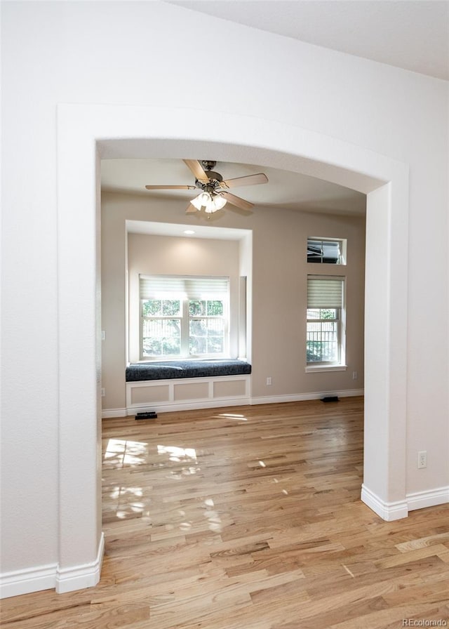 unfurnished room featuring light hardwood / wood-style floors and ceiling fan