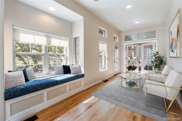 living room with french doors and hardwood / wood-style floors