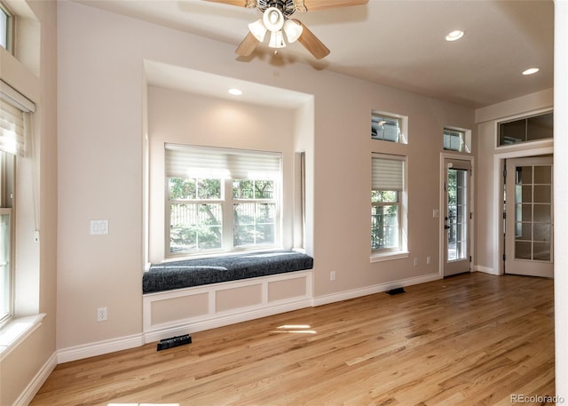 workout area with light hardwood / wood-style floors and ceiling fan