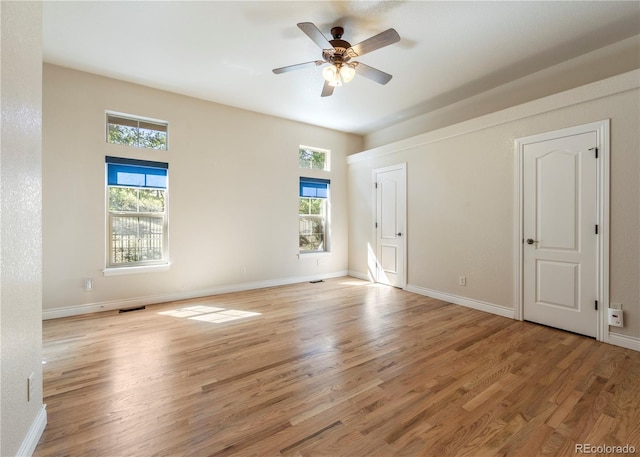 spare room with ceiling fan, light hardwood / wood-style flooring, and plenty of natural light