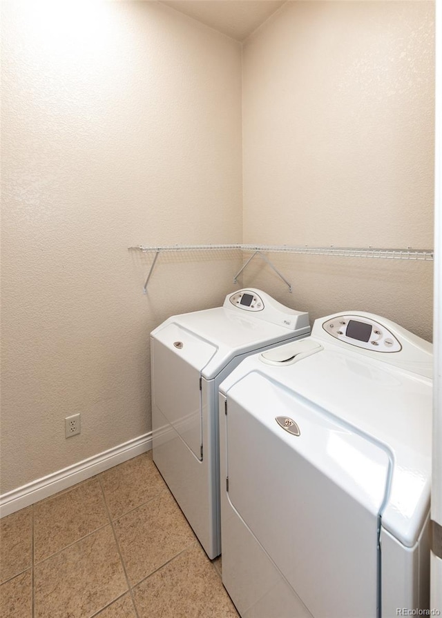 washroom with light tile patterned flooring and washing machine and dryer